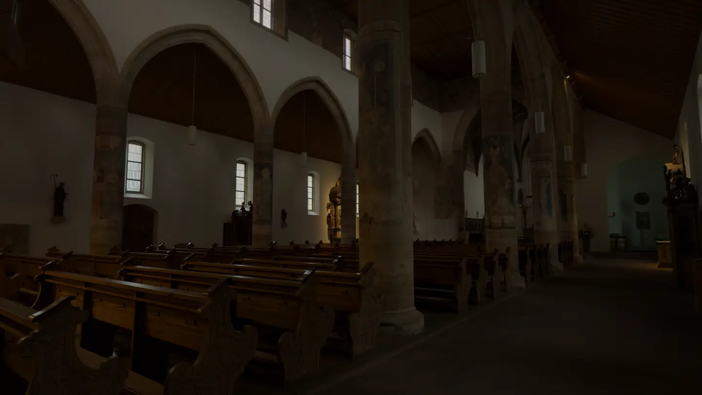 The nave of St. Moriz in Rottenburg am Neckar seen from under the organ gallery: painted round pillars, pointed arches and rows of pews
